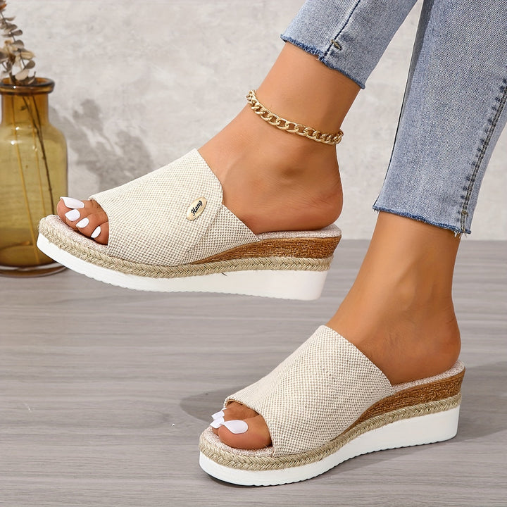 Apricot height-increasing wedge slide sandal paired with jeans