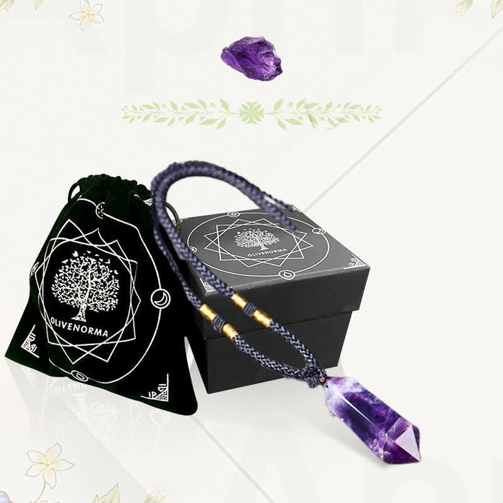 Holistic healing crystal necklace displayed with natural elements