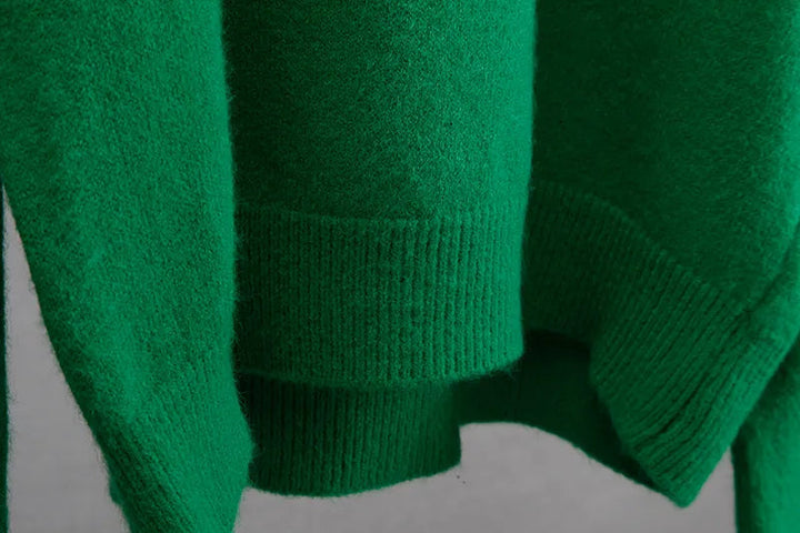Full outfit pairing the green oversized knit pullover with winter accessories