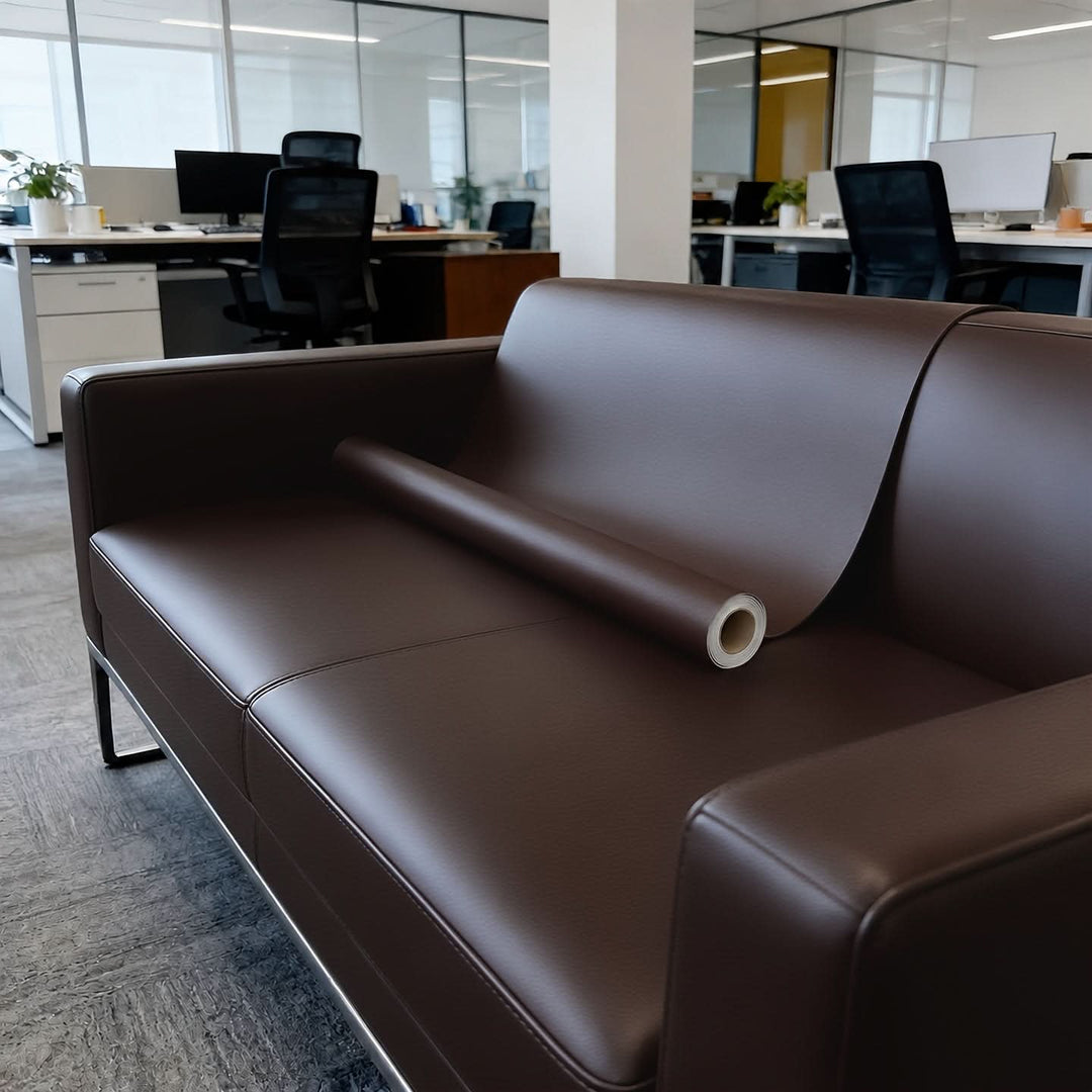 A dark brown vinyl repair patch roll displayed on a contemporary office sofa.