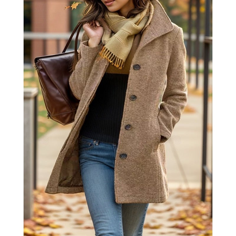 Close-up of a woman in a khaki turn-down collar trench coat with a brown handbag