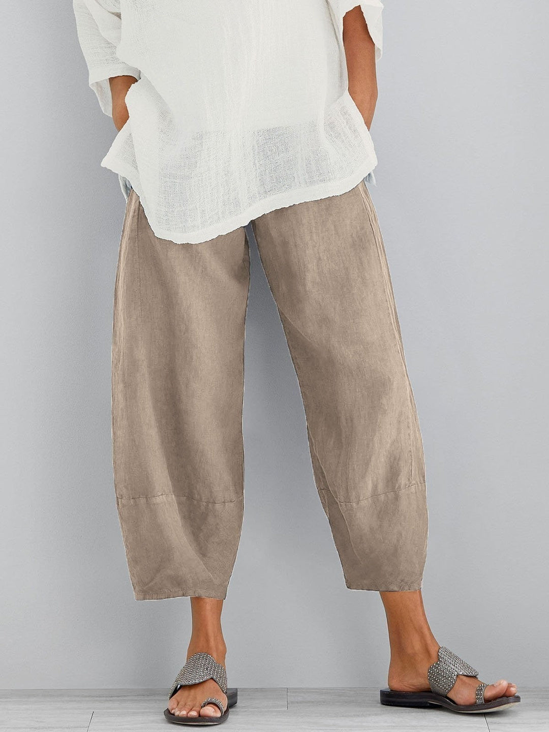 Close-up of fabric texture and button closure on women's hazel neutral casual trousers