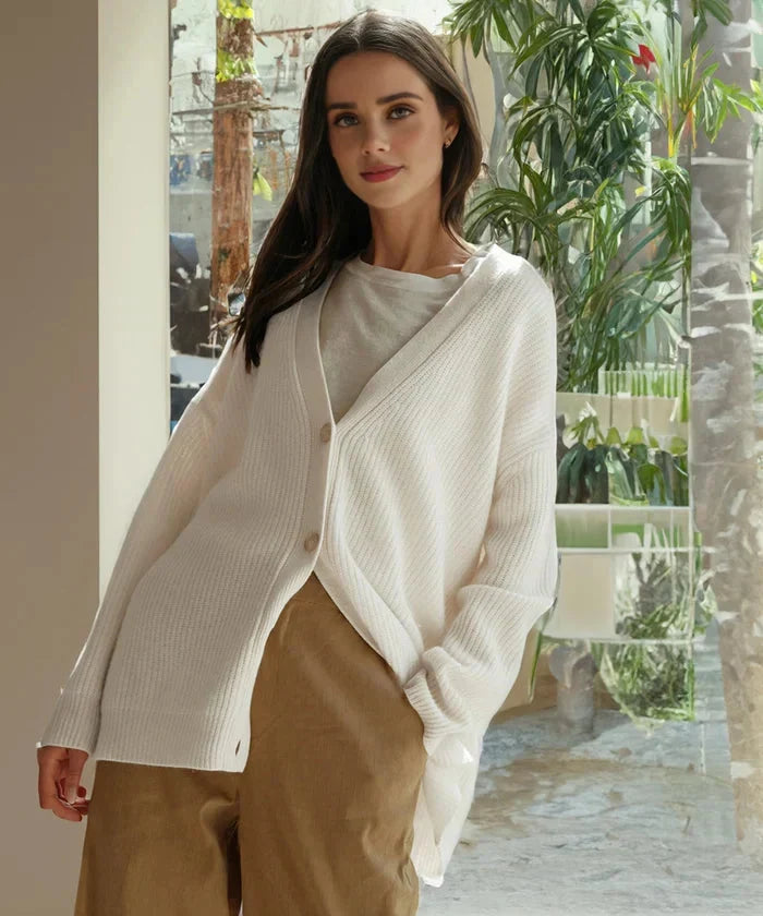 Lifestyle shot of woman wearing cozy knit cardigan vest