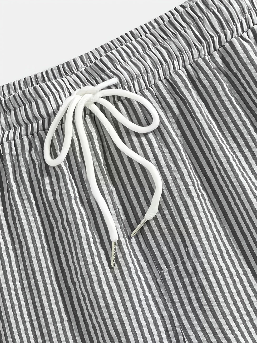 Folded stack of mens casual striped shorts in various colors