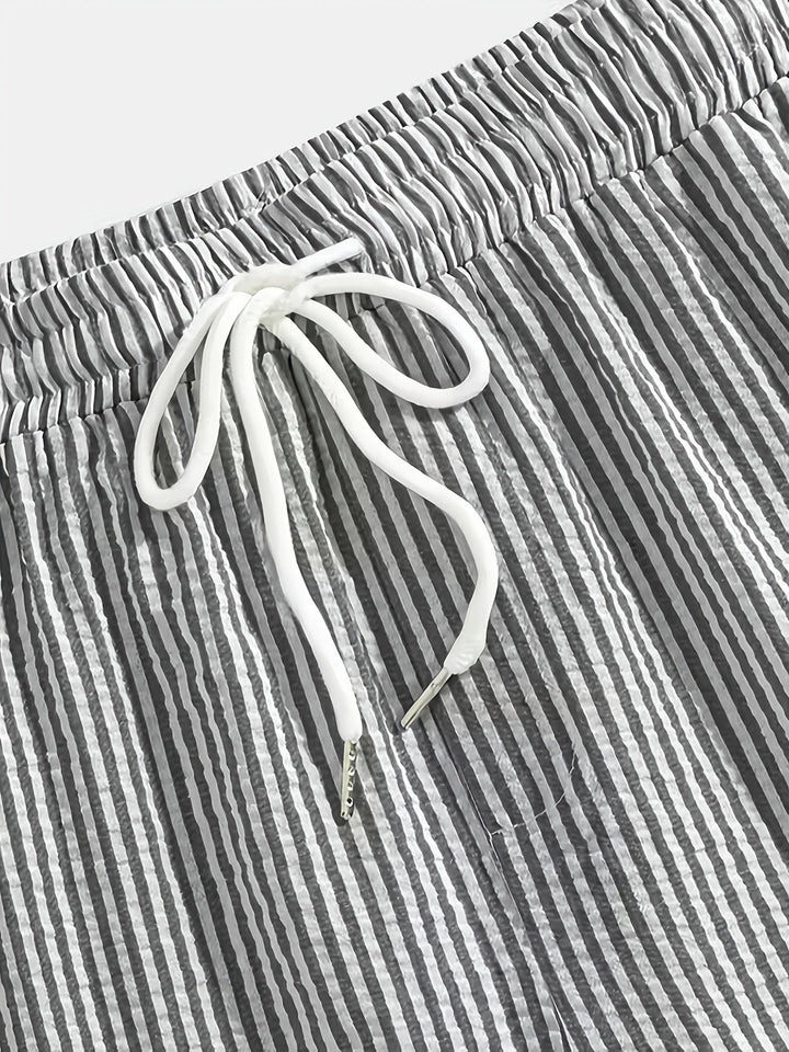 Folded stack of mens casual striped shorts in various colors