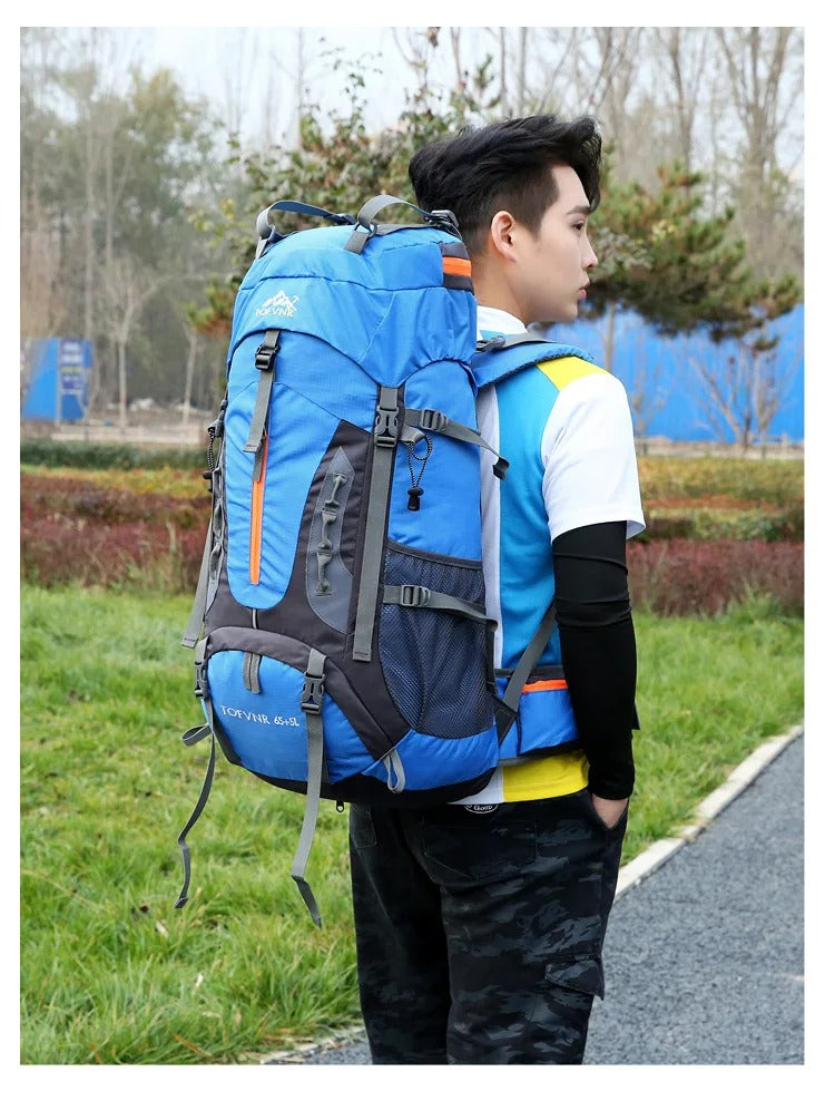Man wearing blue waterproof 65L hiking backpack outdoors