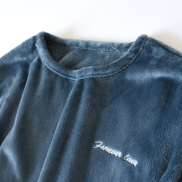 Men's cozy sleepwear set hanging neatly on a wooden hanger