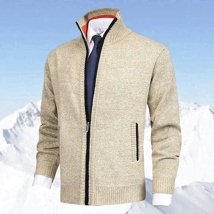 Beige men's zip cardigan featured in front of an outdoor winter mountain landscape
