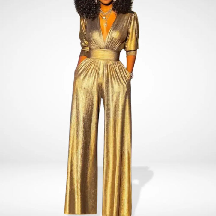 Woman wearing a shimmering gold evening jumpsuit with wide legs