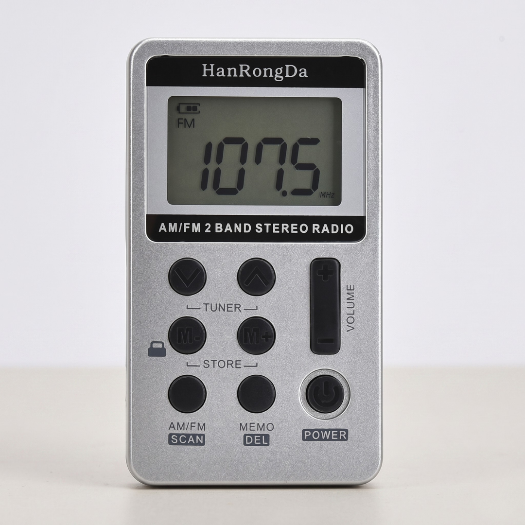 Silver mini metal pocket AM/FM radio displayed against a clean neutral background.
