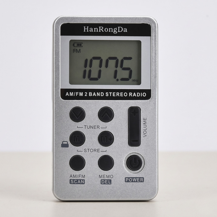 Silver mini metal pocket AM/FM radio displayed against a clean neutral background.