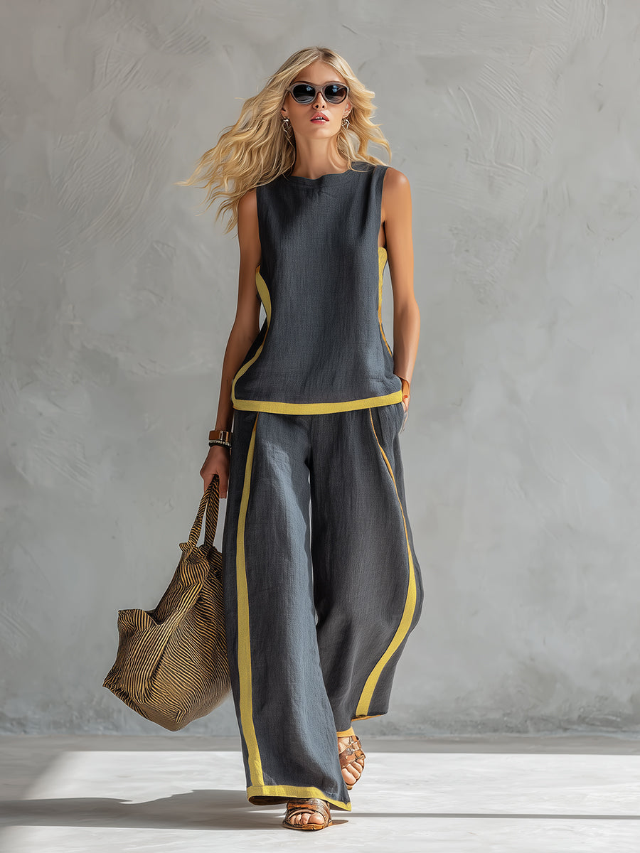 Model wearing women's two-piece wide leg pants set in gray with sleeveless top and contrasting trim