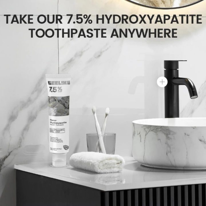 Close-up of the hydroxyapatite toothpaste tube next to bathroom sink setup