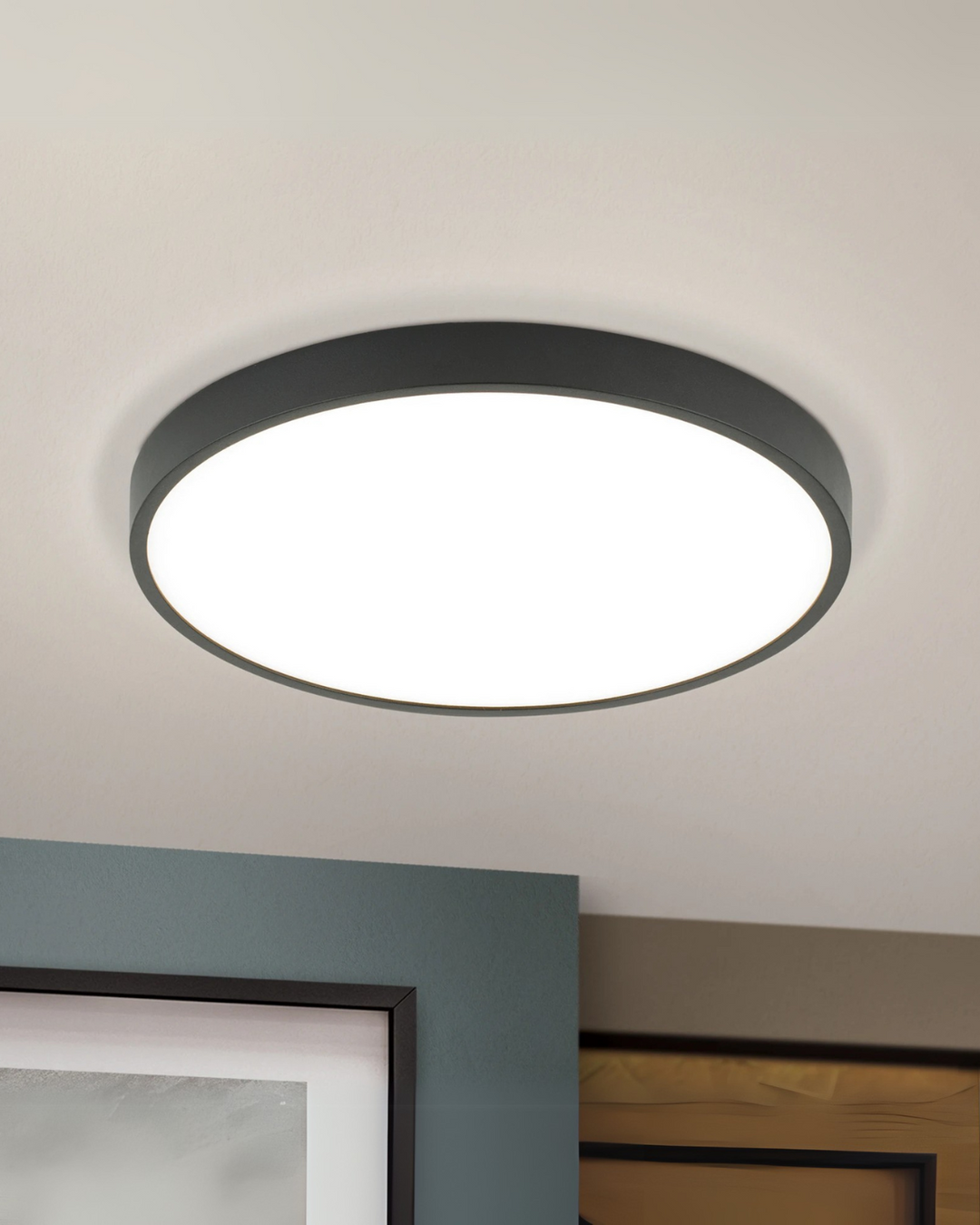 Minimalist disc LED ceiling lamp lighting a modern bedroom interior