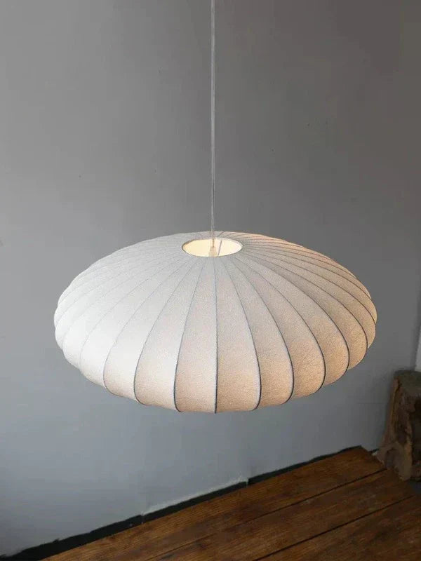 Close-up view of the textured shade and structure of the silk pendant lamp