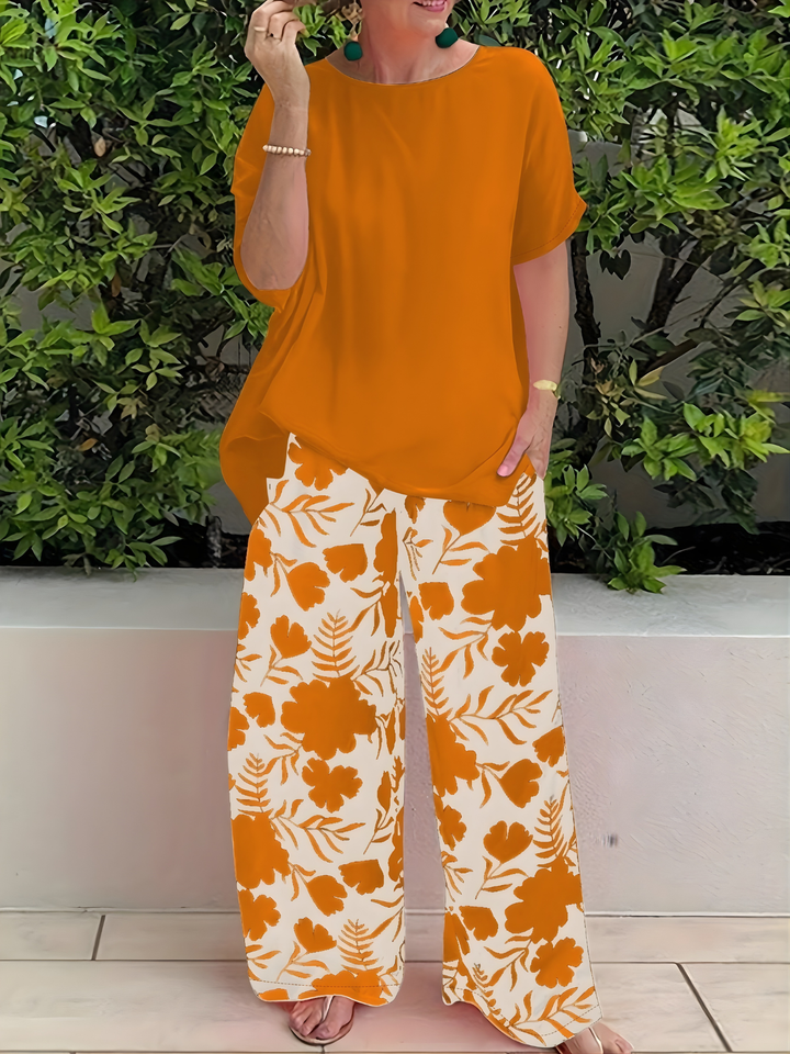 Woman wearing an orange loose top and matching patterned trousers