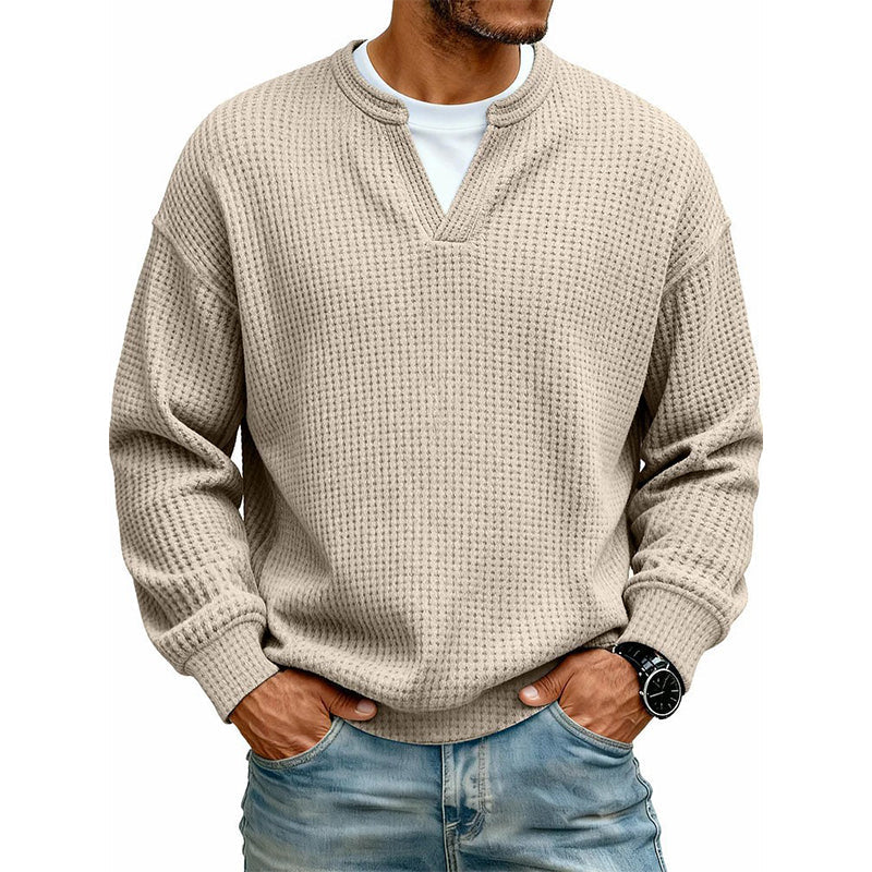 Man wearing an apricot colored casual waffle long sleeve top