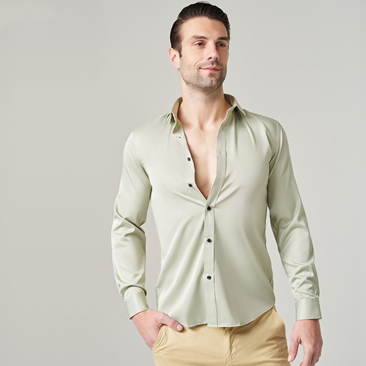 Man wearing a light green long sleeve casual work shirt with khaki trousers