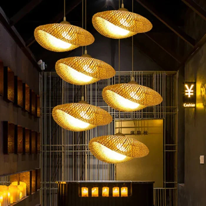 Multiple woven rattan pendant lamps suspended in a restaurant or hallway setting