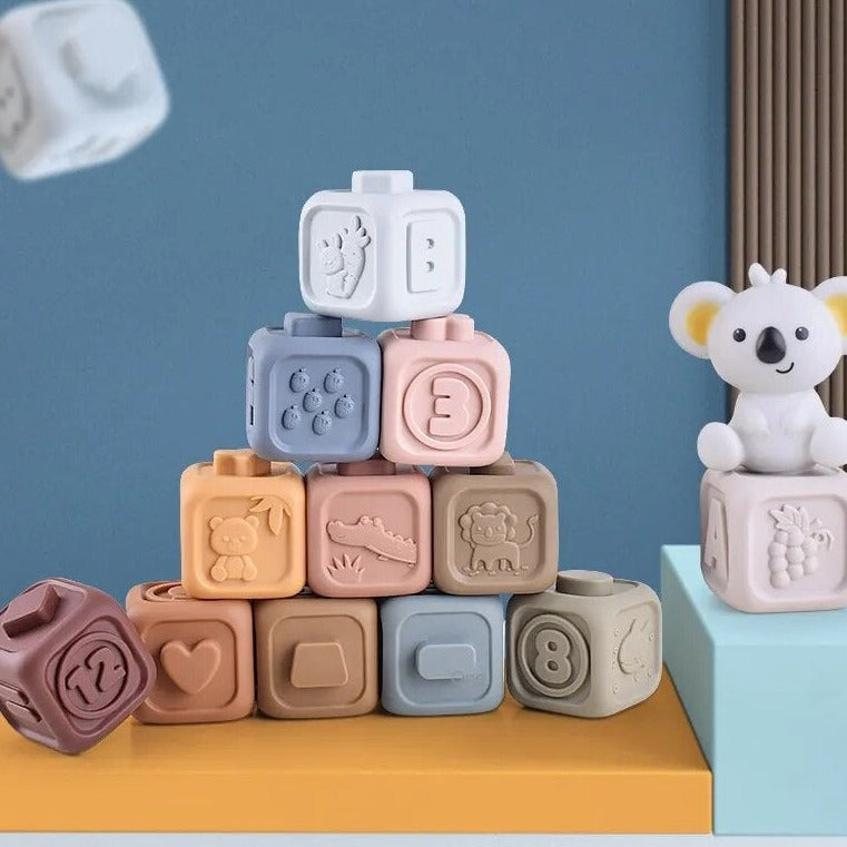 Colourful silicone stacking cubes arranged in a pyramid with a koala figure
