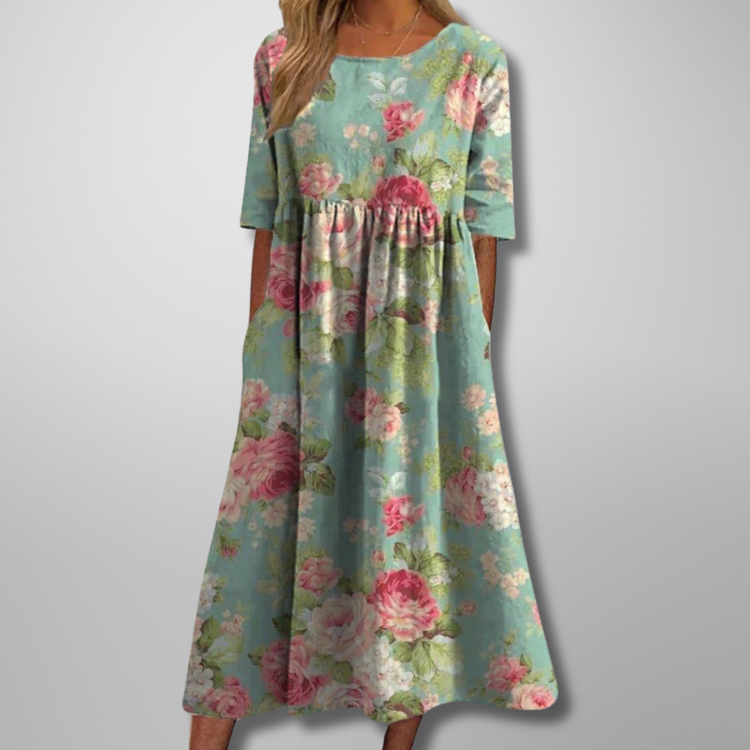 Model wearing green short-sleeve floral midi dress with botanical pattern