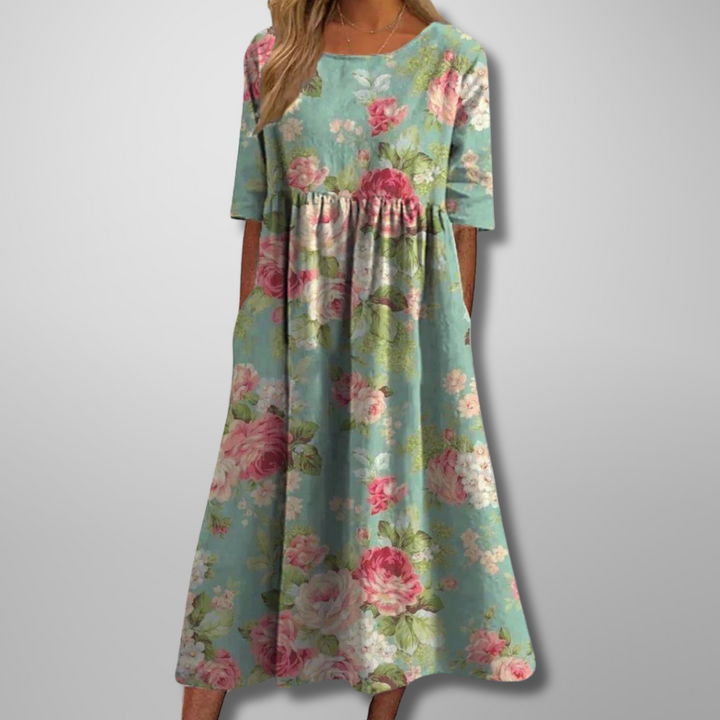 Model wearing green short-sleeve floral midi dress with botanical pattern