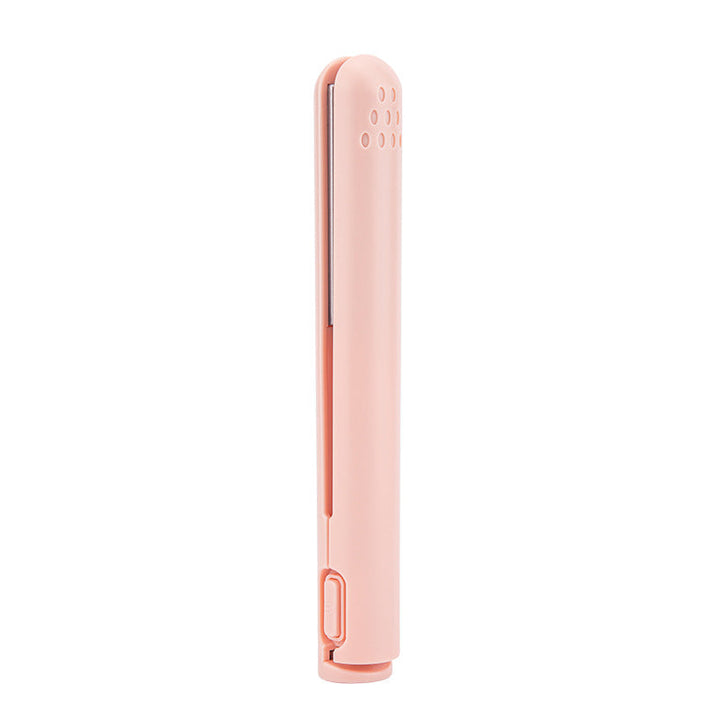 Portable hair styler safety cap on, showing compact size for luggage packing