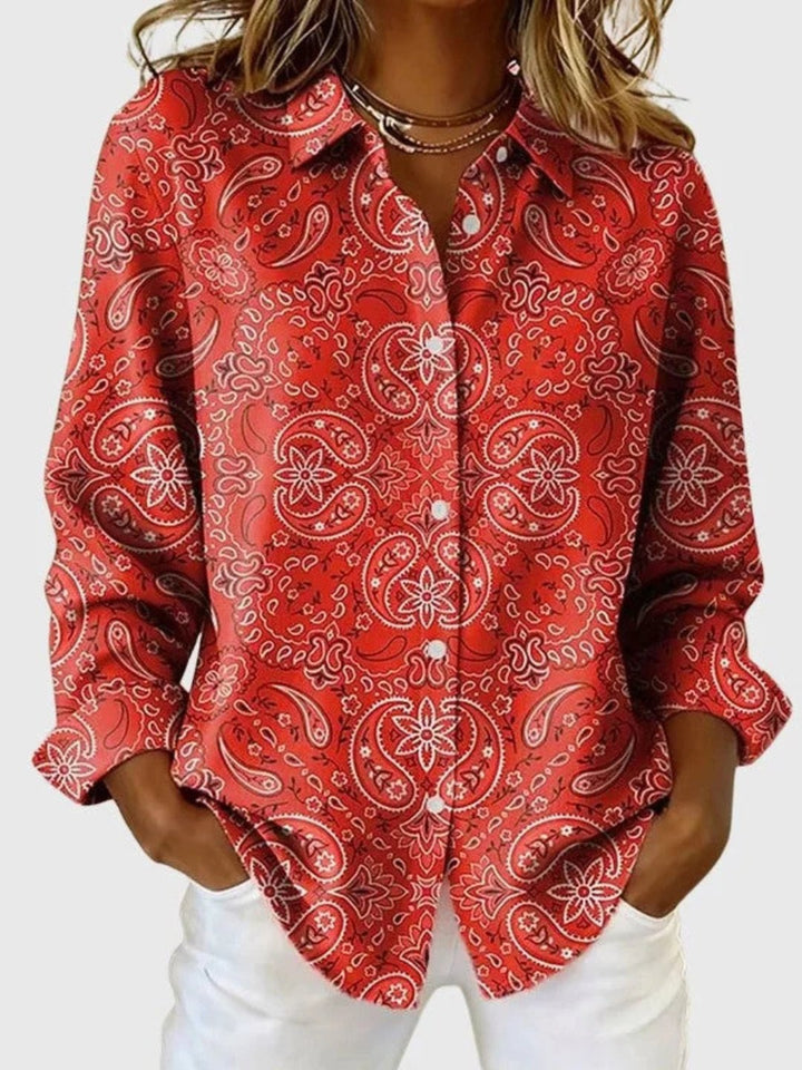 Detailed shot of paisley print fabric on women's long sleeve blouse