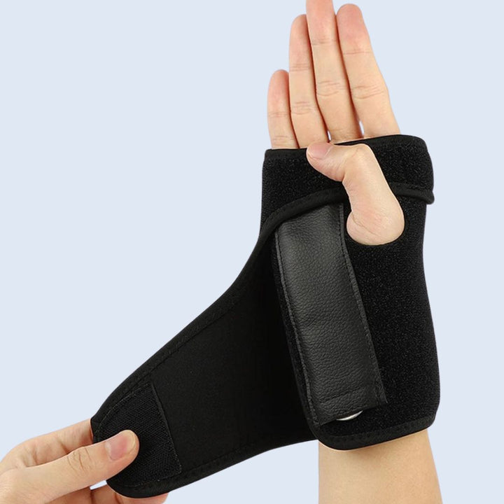Close-up of a black wrist splint with metal support worn on the right hand
