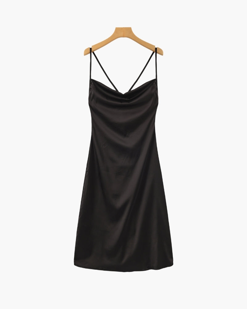 Black satin slip dress displayed on a wooden hanger against a white background