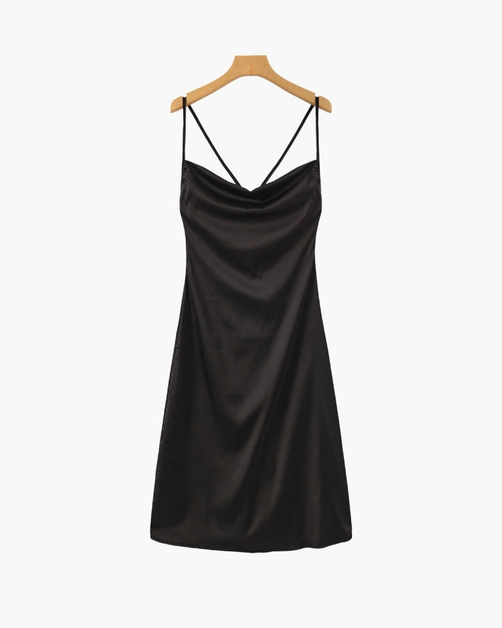 Black satin slip dress displayed on a wooden hanger against a white background