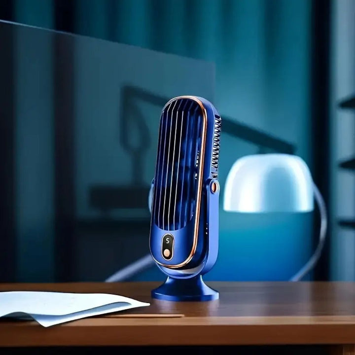 Coolux blue USB desk fan on a wooden desk next to paper