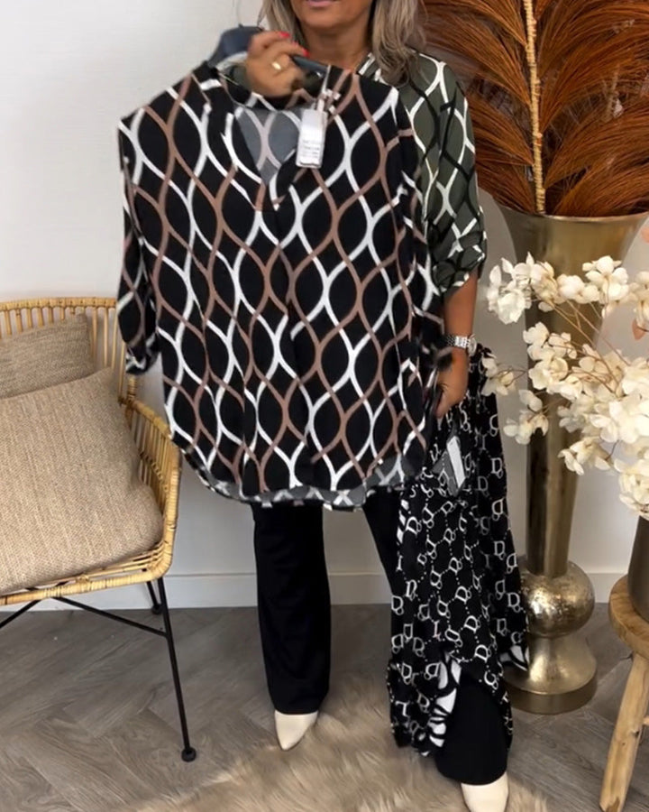 Display of the brown geometric print blouse held on a hanger