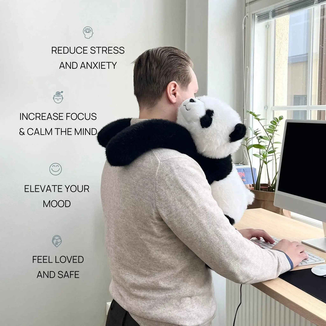 Man sitting at a desk while wearing the weighted panda plush for focus and stress relief