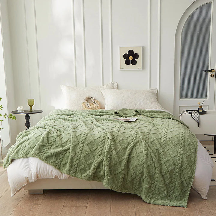 Close-up of warm luxury bedroom blanket showing thick plush fabric weave