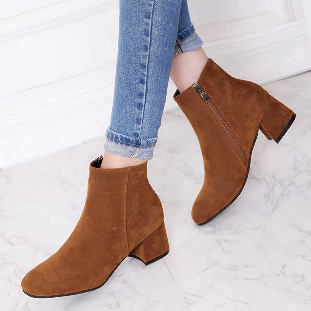 Close-up texture of premium material on women's brown ankle boots