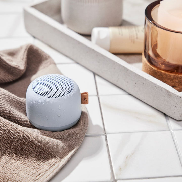 Waterproof Bluetooth bathroom speaker with color-changing mood light in a shower