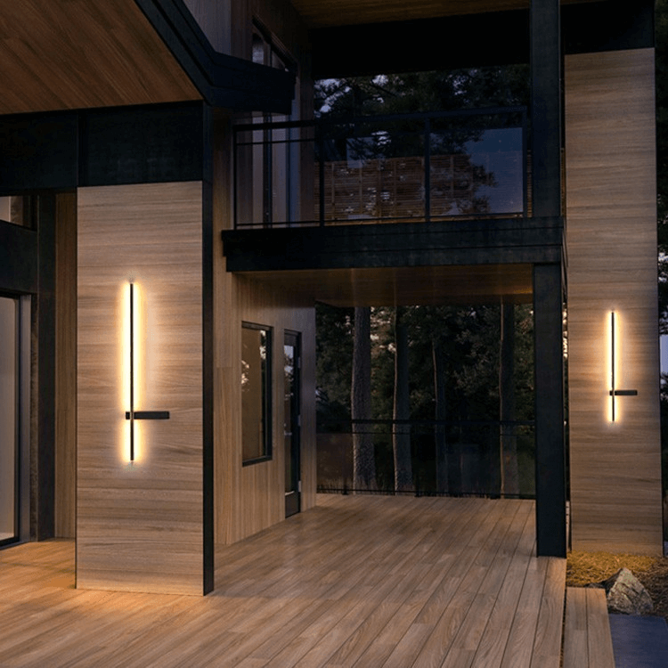 Modern outdoor LED wall lamp illuminating an exterior brick house wall at night