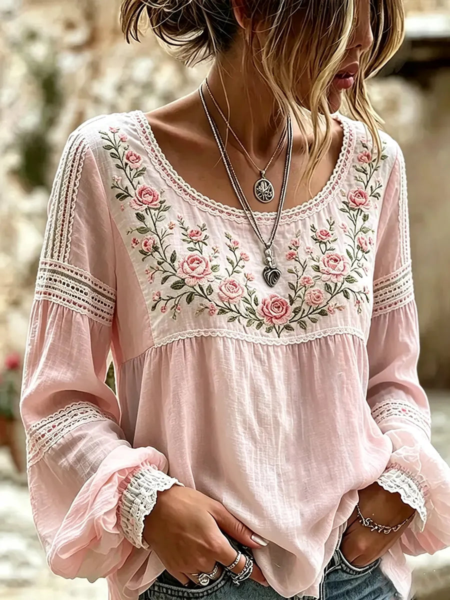 Close-up of a woman in a pink embroidered long-sleeve casual blouse