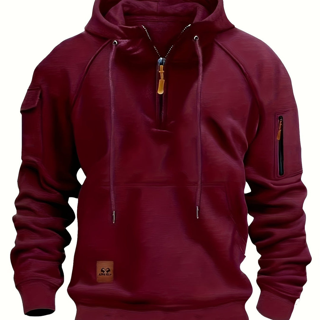Folded stack of men's utility hoodies in various neutral color options.