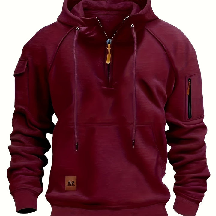 Folded stack of men's utility hoodies in various neutral color options.