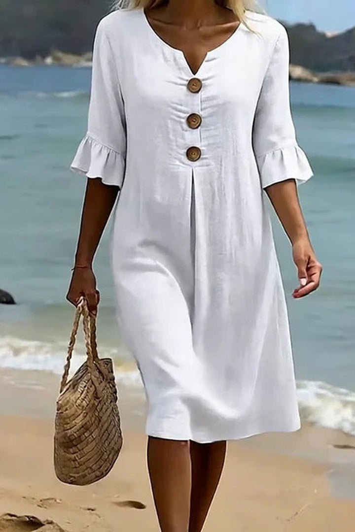 Close-up of the white Mitzi dress featuring decorative buttons