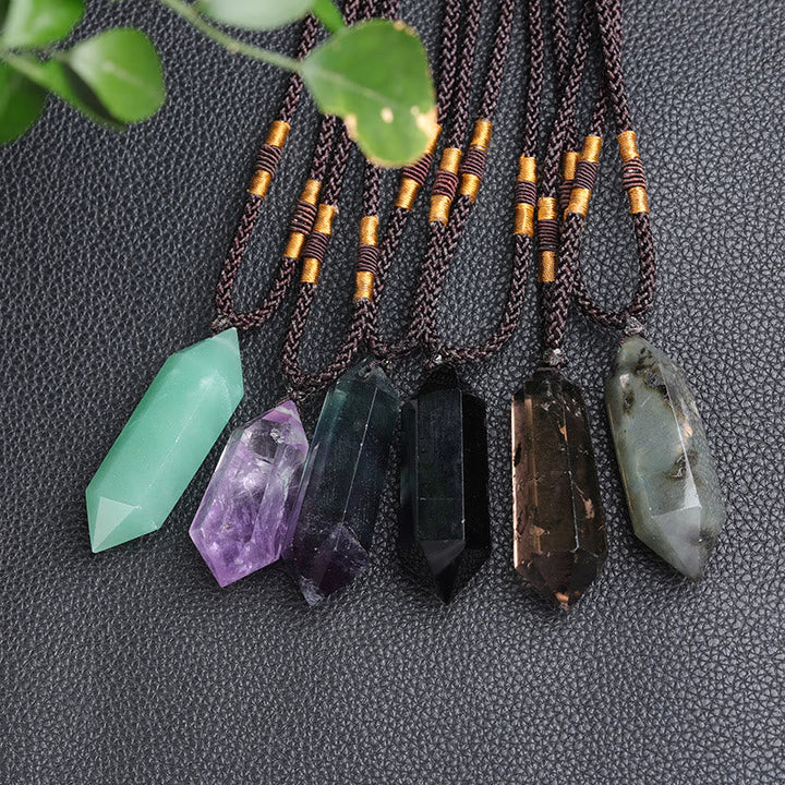 Minimalist natural gemstone jewelry piece resting on a soft fabric