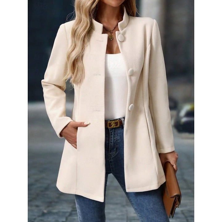 Side profile of women's tailored trench coat featuring a chic stand collar