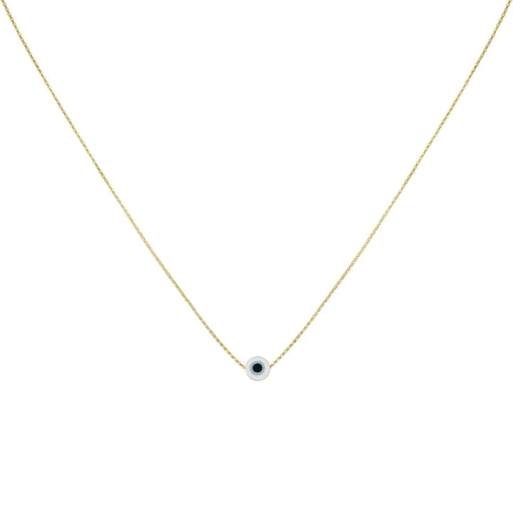 White evil eye charm necklace with gold chain displayed flat
