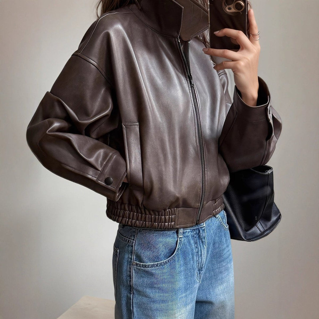 Woman wearing dark brown bomber jacket with jeans