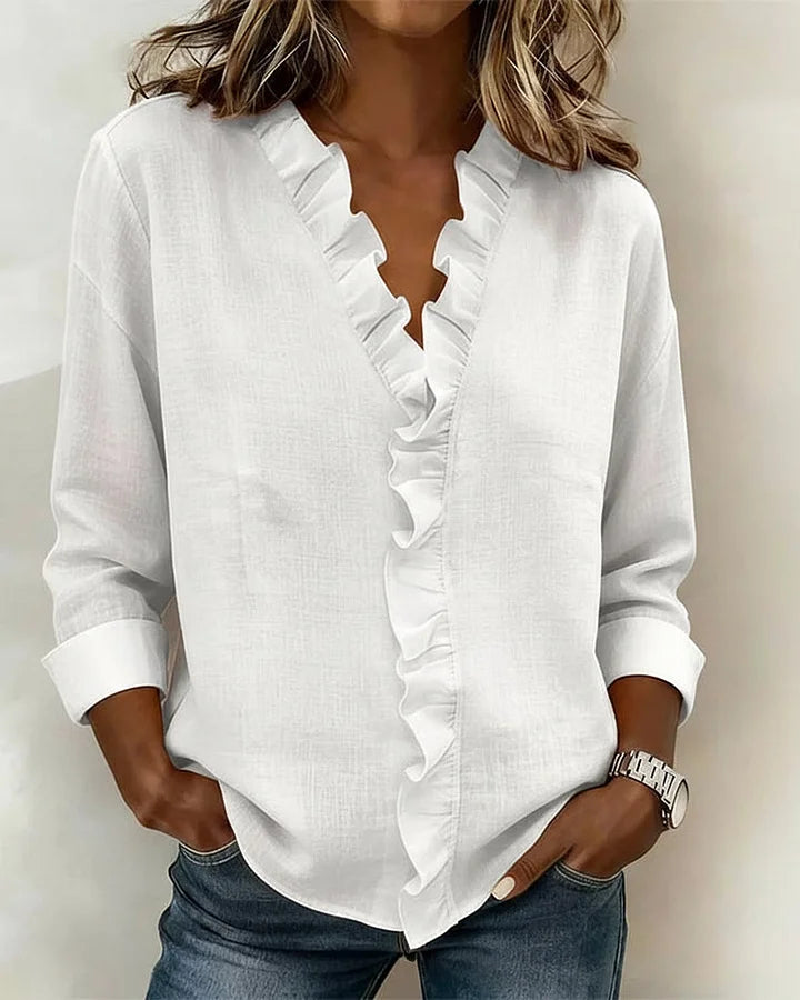 Woman wearing white lightweight V-neck ruffled blouse