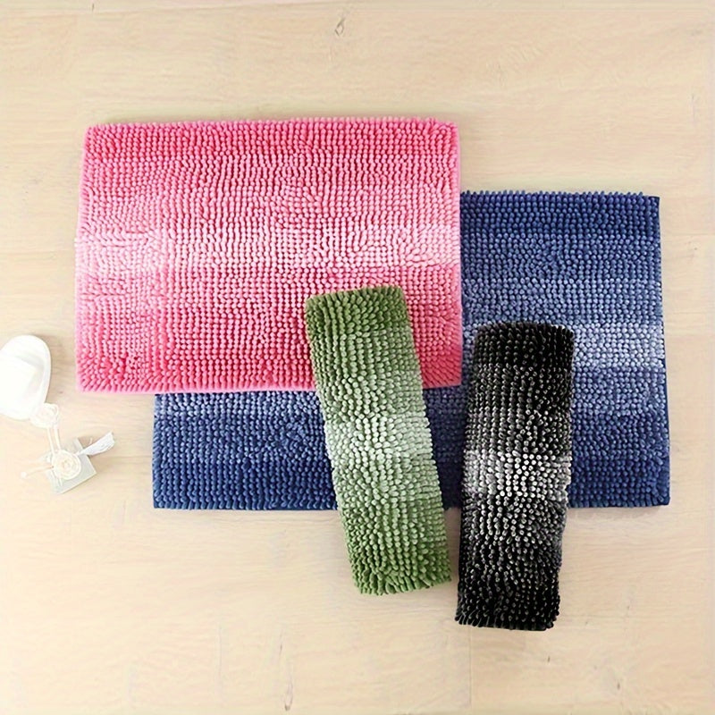 Assorted colors of chenille bath mats laid out flat and rolled