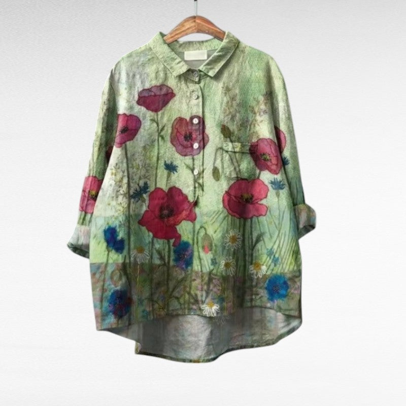 Women's floral summer blouse in multicolor with button closure and long sleeves displayed on a hanger