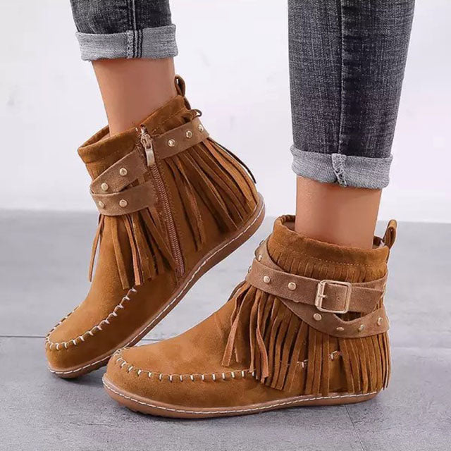 Brown fringed ankle boots with buckle detail worn with cuffed jeans